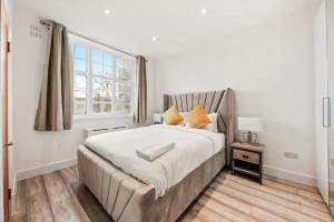 a bedroom with a large bed and a window at The Grosvenor Residences in London