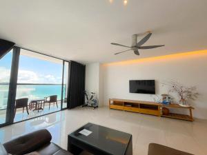 a living room with a ceiling fan and a television at Pooh House 9 in Vung Tau