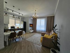 a living room with a table and a dining room at 3 room Gagarin Park Residential Complex near MEGA Shopping Mall in Almaty