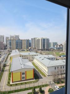 a view of a city with buildings and a street at 3 room Gagarin Park Residential Complex near MEGA Shopping Mall in Almaty