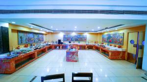 a large bathroom with many sinks and mirrors at Hotel the Plaza in Hyderabad