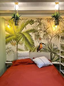 a bedroom with a bed with a mural of palm trees at Vita lenta Roma Pigneto terrazza in Rome