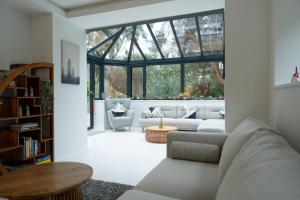 a living room with a couch and a large window at Foxgloves retreat in Torquay