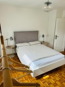 a bedroom with a large white bed with two lamps at A14 Three Bed Apartment City Center in Heidenheim an der Brenz