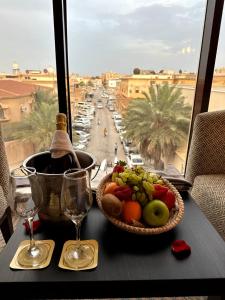 un tavolo con un cesto di frutta e una bottiglia di vino di وحدات فندقية خاصة a Al Jubayl