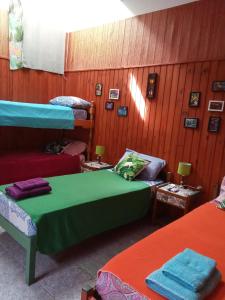 a room with three bunk beds and a couch at Eka Hotel in Nueva Palmira