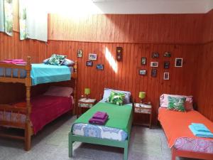 a room with two bunk beds and two chairs at Eka Hotel in Nueva Palmira