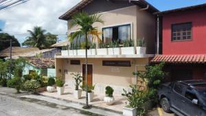 a house with a lot of plants in front of it at Villa Marina in Arraial d'Ajuda