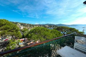 a balcony with a view of a city and the water at Tea Apartment in Santa Margherita Ligure