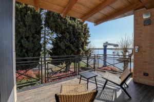a patio with two chairs and a table on a balcony at DOLCERIVA - The Lakefront Suite in Peschiera del Garda