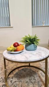 a table with a plate of fruit on it at Charming 1-Bed Apartment in Leeds in Leeds