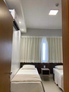 Ein Bett oder Betten in einem Zimmer der Unterkunft Apartamento Lagoa Ecotowers resort