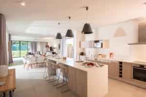 a kitchen with white counters and a dining room at Marguery Villas in Rivière Noire