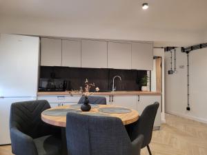 a kitchen with a table and chairs in a room at AXO-HOSTELS in Stalowa Wola