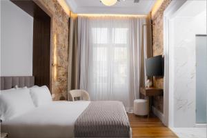 a hotel room with a bed and a window at La Divina in Athens