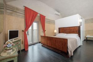 a bedroom with a large bed and a television at Asso Residence Narni in Narni