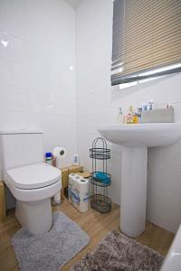 a bathroom with a white toilet and a sink at Sweet Dream Lodge in Manchester