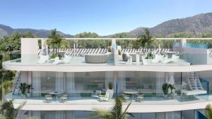 an aerial view of a building with chairs and tables at Panoramic Seaview Penthouse The Wave in Fuengirola
