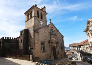 an old church with a tower with a clock on it at MyStay - Casa Matriz Séc XVI in Penafiel