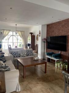 a living room with a couch and a tv at Casa Bignonia in Salteras