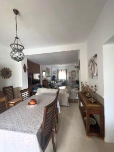 a kitchen and living room with a table and a couch at Casa Bignonia in Salteras