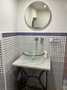 a bathroom with a glass sink and a mirror at Trentapassidairolli in Genova +25 photos