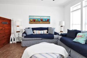 a living room with two couches and a painting on the wall at Bucket List by Pristine Properties Vacation Rentals in Mexico Beach