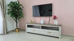 a living room with a television on top of a table at Newly furnished luxury apartment with sea view in high floor in Ras al Khaimah