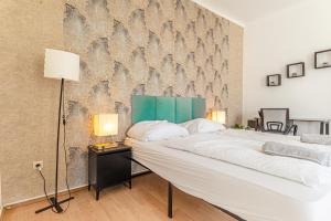 a bedroom with a large bed and a wall with birds at Vienna Getaway -2BR Apartment Central & Comfort in Vienna