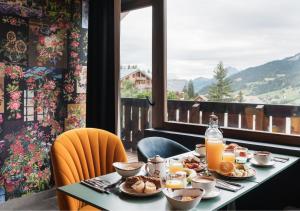 a breakfast table with a view of a mountain at Mamie Megève in Megève