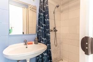 a bathroom with a sink and a shower at Vienna Getaway -2BR Apartment Central & Comfort in Vienna