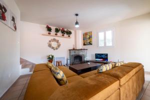 a living room with a couch and a fireplace at Hubstay - Hillside Home in Platres in Platres