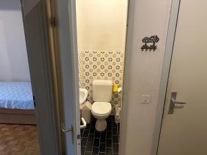a small bathroom with a toilet and a sink at Résidence Europe in Brussels