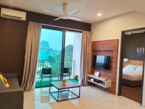 a living room with a bed and a tv at Lost World of Tambun, Sunway Onsen Studio, 1BR, 2-4pax in Tambun