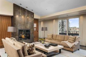 a living room with a couch and a fireplace at Crane Penthouse in Portland