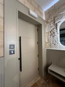 a sliding door in a room with a stone wall at Domingo x Casa Norte in Birgu