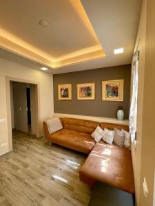 a living room with a brown leather couch at Le Suite Sul Corso in Cagliari