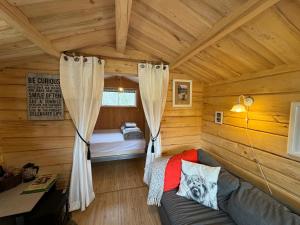 a room with a couch in a log cabin at The Hideout Log Cabin- 2km to Klarälvsbanan and swimming area in Munkfors