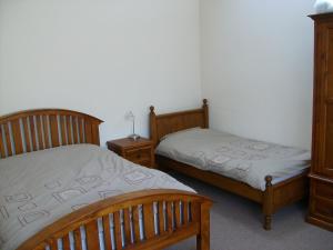 A bed or beds in a room at Knotts Farm Holiday Cottages 