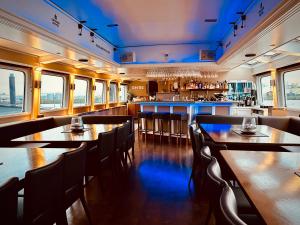 a restaurant with tables and chairs and a bar at Eventschiff Grosser Michel in Hamburg