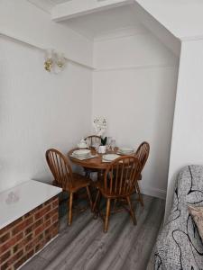 a dining room table and chairs in a room at Luxury Home in Lewisham in Bromley