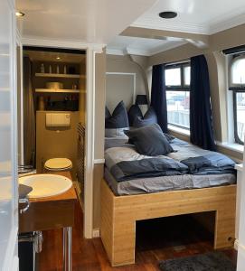 a bedroom with a bed and a sink in it at Eventschiff Grosser Michel in Hamburg