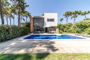 a villa with a swimming pool and a house at Villa Jasmine in Aroeira