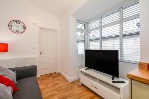 a living room with a flat screen tv on a stand at Henry Court Apartment 3 in York