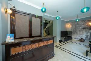 a barber shop with a reception desk in a room at Raymond Blue Hotel in Istanbul