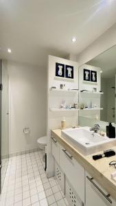a bathroom with a sink and a toilet and a mirror at ApartmentInCopenhagen Apartment 1601 in Copenhagen