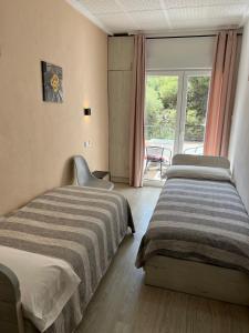En eller flere senge i et værelse på Casa Durán Alicante