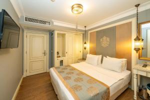 a bedroom with a large bed with white pillows at Raymond Blue Hotel in Istanbul