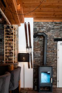 a wood stove in a room with a brick wall at Hotel Sonnenalm Stuhleck in Spital am Semmering