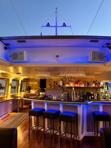 a bar in a restaurant with blue lighting at Eventschiff Grosser Michel in Hamburg